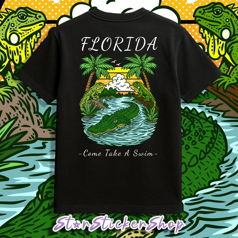 Black Florida graphic tee with palm trees, swamp artwork, alligator illustration, and Come Take A Swim design.
