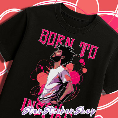 Black t-shirt with a graphic of a man and text 'Born to Inspire' on a pink and white geometric patterned background.